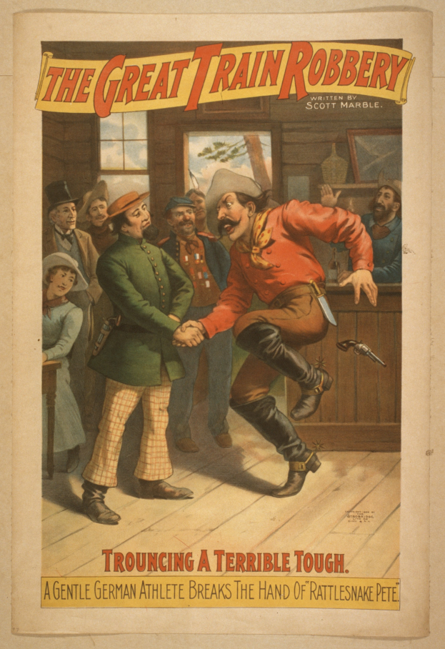 Ein Plakat zeigt eine Gruppe von Menschen auf einem Boden, einer hält eine Waffe, mit Text oben und unten: "Der große Zugraub - Trouching ein schreckliches Tough".